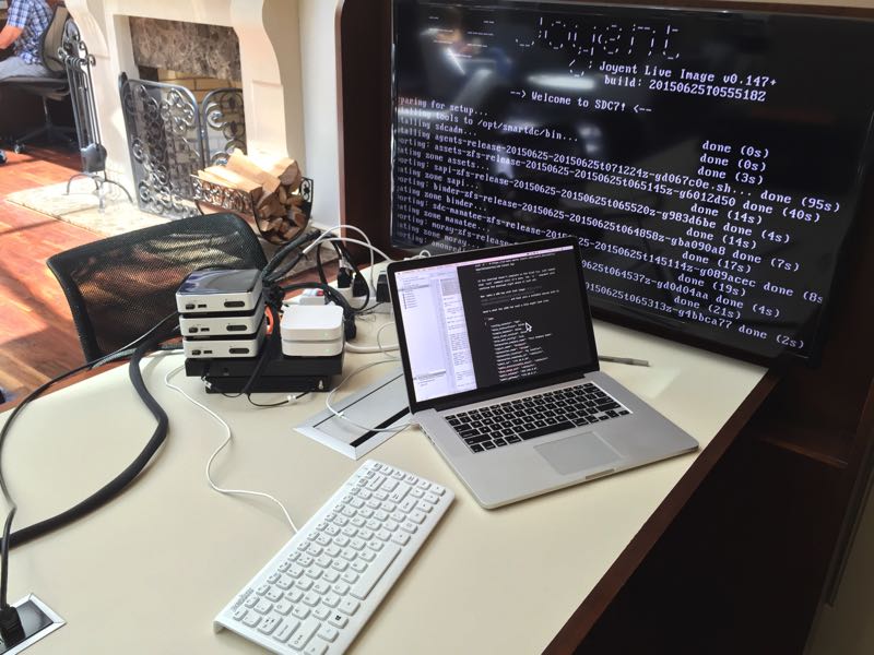 My portable data center, including NUCs, switch, router, WiFi, and my laptop in a hotel lobby